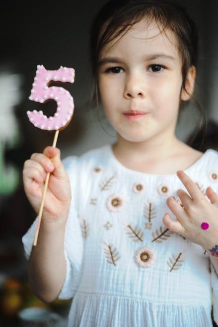 Child holding 5 cookie representing future growth
